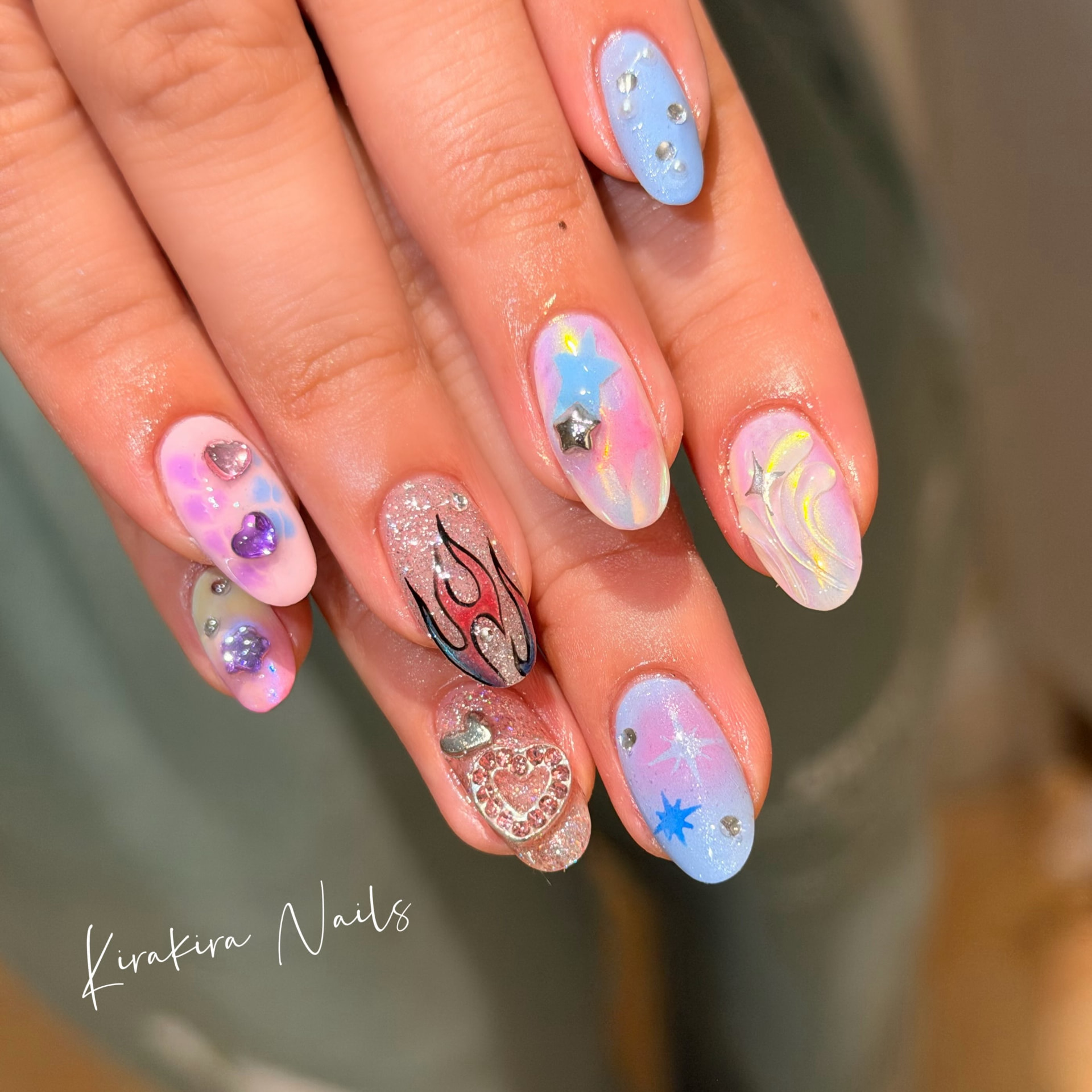 Pastel almond nails with 3D hearts, stars and flames